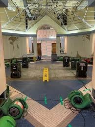 Industrial vortex air movers and LGR dehumidification equipment deployed for structural drying in a large building atrium